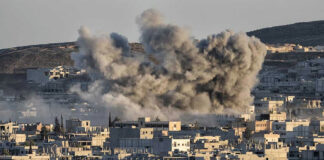 Smoke rising from buildings in a city.