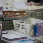 USPS Ordered to DEFY President Trump… USPS worker handling mail-in ballots at a sorting facility.