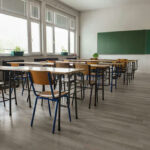 Pen Cameras EXPOSE Shocking School Scandal Empty classroom with desks, chairs, windows, and chalkboard.