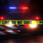 66 Counts Against ‘Reformed’ Killer – System FAILS? Police car behind yellow caution tape at night.