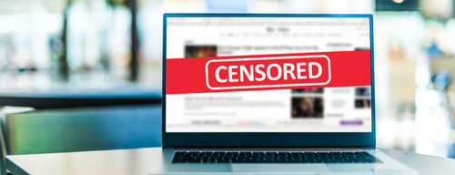 shutterstock_1845468790 Laptop screen with CENSORED banner over webpage