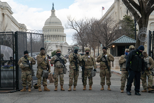 shutterstock_2026076819.jpg Armed soldiers standing guard outside the Capitol building