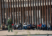 CAUGHT: Chinese Nationals in Camouflage at Texas Border… Border patrol agent with group of seated immigrants.