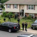 Law enforcement officers conducting a raid in a residential neighborhood