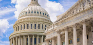 U.S. Capitol dome with blue sky background.