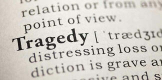 Close-up of the word Tragedy in a dictionary