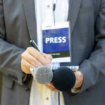 NYT ACCUSED Of Burying POLITICIAN’S Bombshell Press member holding microphones and taking notes.