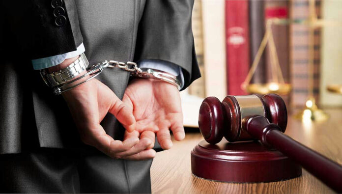 516724744 Person in handcuffs near gavel and scales of justice.