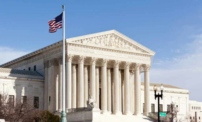 96721225-3 United States Supreme Court building with American flag.