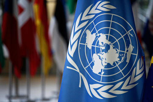 shutterstock1091235845-1jpg United Nations flag with various country flags in background.
