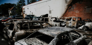 Burned cars in a parking lot after a fire