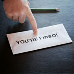 Teacher AXED Over HIGHLY INAPPROPRIATE Skits Hand pointing to an envelope on a desk