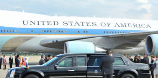 Presidential limousine parked in front of Air Force One at an airport