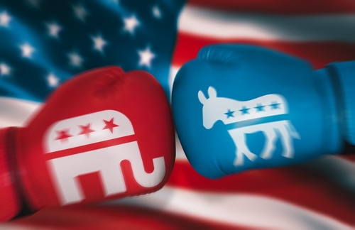 Boxing,Gloves,With,Symbols,Of,Usa,Parties,On,Background,Of Red and blue boxing gloves representing Republican and Democratic parties against an American flag background