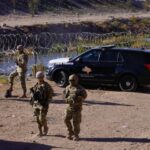 MASSIVE Cartel Tunnel HIDDEN in Plain Sight! Military personnel and law enforcement officers near a border area with vehicles and barbed wire