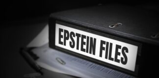 A black binder labeled 'EPSTEIN FILES' with papers and office supplies nearby