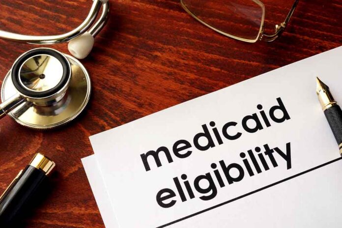 shutterstock_640488934-1- Medicaid eligibility form with stethoscope and pen on desk