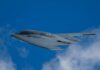 Stealth bomber flying against a clear blue sky