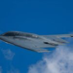Two Pilots, One Nuke: Why Now? Stealth bomber flying against a clear blue sky