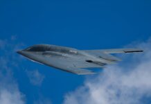 Two Pilots, One Nuke: Why Now? Stealth bomber flying against a clear blue sky