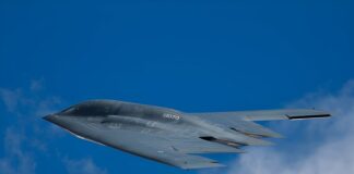 Stealth bomber flying against a clear blue sky