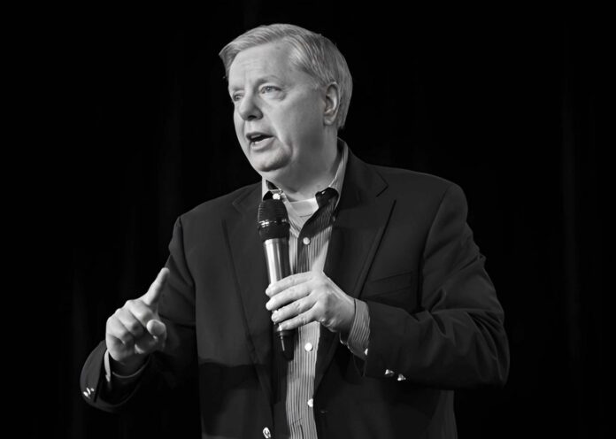 Man speaking into a microphone on stage