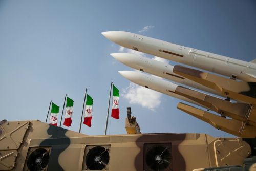 shutterstock1621002841-2jpg Missiles on launchers beside Iranian flags.