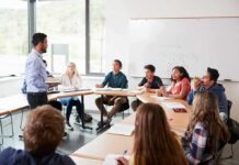 Teacher speaking to students in a classroom discussion