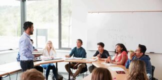 Teacher speaking to students in a classroom discussion