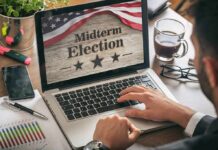 Person using laptop displaying midterm election screen