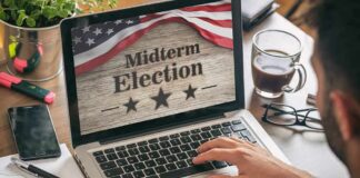 Person using laptop displaying midterm election screen