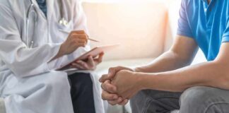 Doctor consulting a patient on a sofa