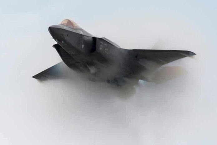 shutterstock_1638650581-1 Stealth fighter jet piercing a vapor cloud