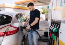 Hormuz Chaos Slams Wallets—What’s Coming? Man fueling a silver car at a gas station