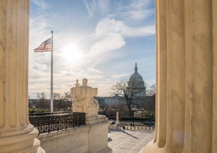 Washington,,Dc,,Us-february,6,,2023:,View,Of,The,Us,Capitol U.S. Capitol dome viewed between marble columns at sunset