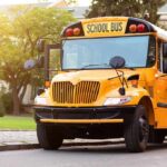 School Bus Inside Building — What Went Wrong? Yellow school bus with stop sign extended