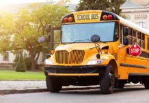 School Bus Inside Building — What Went Wrong? Yellow school bus with stop sign extended