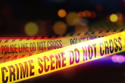 Yellow,Tape,Showing,Text,"crime,Scene,Do,Not,Cross",Restricting Yellow police tape marking a crime scene with blurred lights in the background