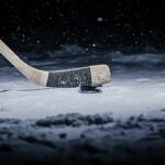 Blackhawks’ Power Play: Bedard Locked, For Now Hockey stick poised over a puck on snowy ice