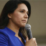 One Word Sparks An Intelligence Loyalty Test Woman in blue blazer holding a microphone.