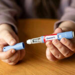 Ozempic-Style Drugs May Quiet More Than Hunger Hands holding an Ozempic injection pen.