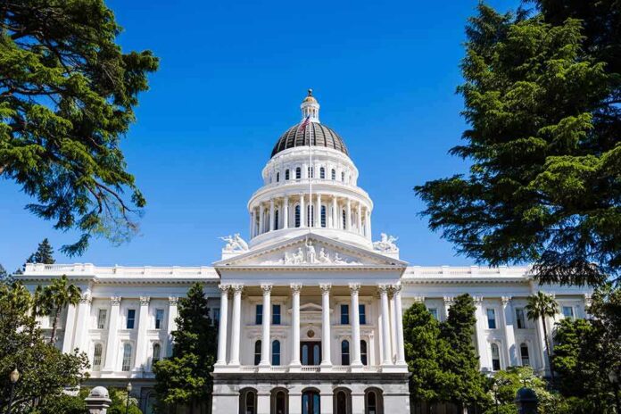 shutterstock_1071074870 State capitol building with white dome and columns framed by trees