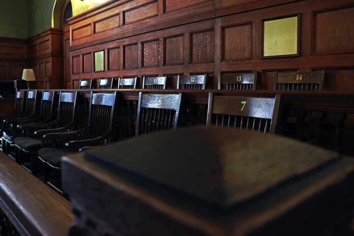 shutterstock_1132288550 Empty wooden jury box with numbered chairs