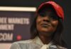 Legal Threats Escalate Owens–Crowder War woman in a red cap holding a microphone
