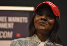 Legal Threats Escalate Owens–Crowder War woman in a red cap holding a microphone