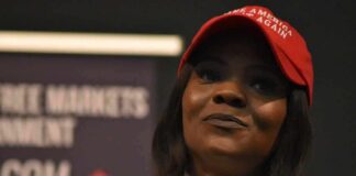woman in a red cap holding a microphone