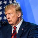 CNN Star Torches Trump — What Crossed the Line? man at podium speaking into microphone