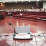 City Hall Faces One Wild Party Request Conference microphone on a podium in a courtroom