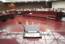 City Hall Faces One Wild Party Request Conference microphone on a podium in a courtroom