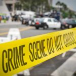 Daylight Bronx Horror — School Aide Down crime scene tape stretches across a blocked city street